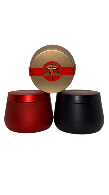 Three spice containers in red, black, and gold colors with decorative lids.